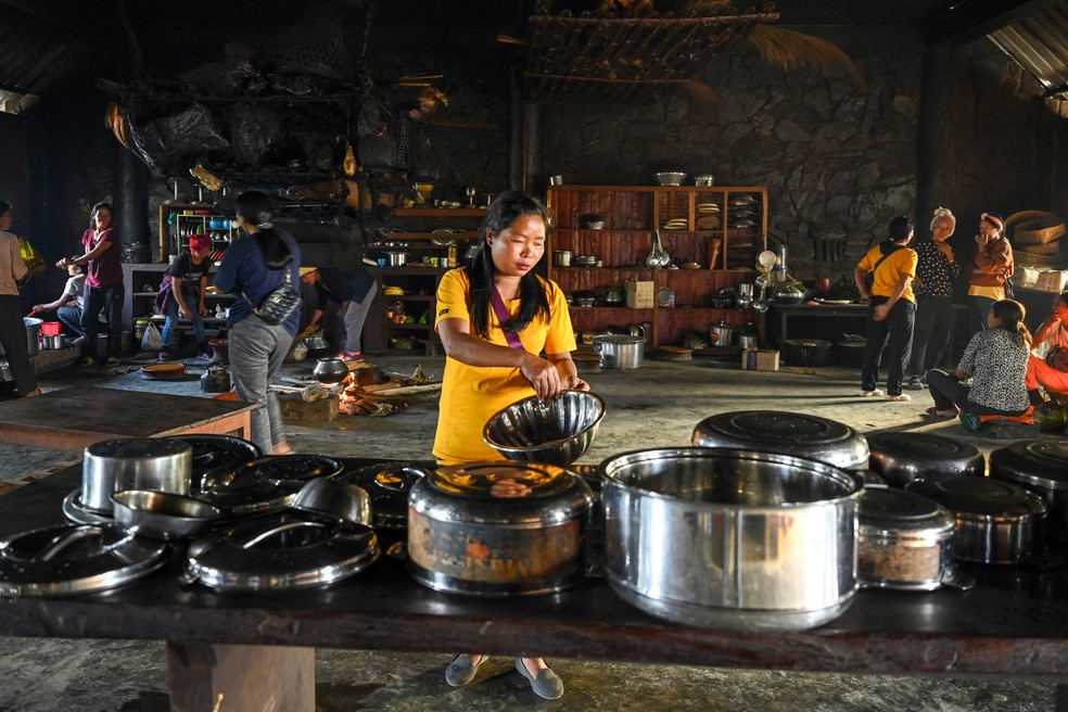 Mulheres da tribo Konyak cozinham na cozinha da residência de seu rei — Foto: Arun Sankar / AFP